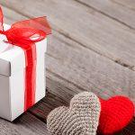 Valentines day gift box and hearts on wood